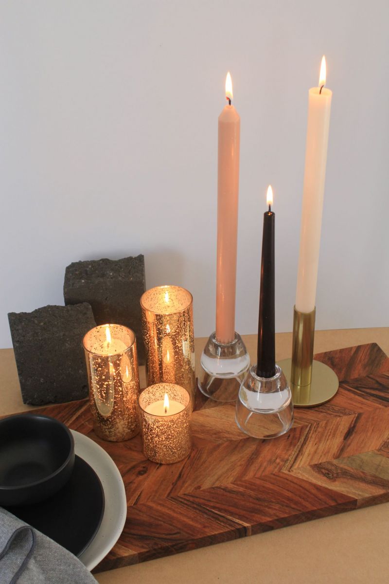 Image of contemporary minimal tablesetting with black and taupe taper candles and gold candle holders
